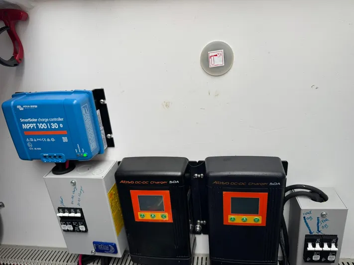  Yacht Photos Pics Electrical components on a 2020 Jeanneau NC 1095 boat, featuring chargers and a solar controller.
