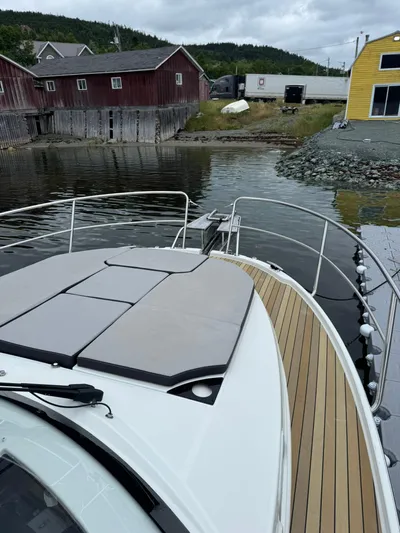  Yacht Photos Pics Jeanneau NC 1095 boat docked near rustic buildings and calm water, 2020 model.