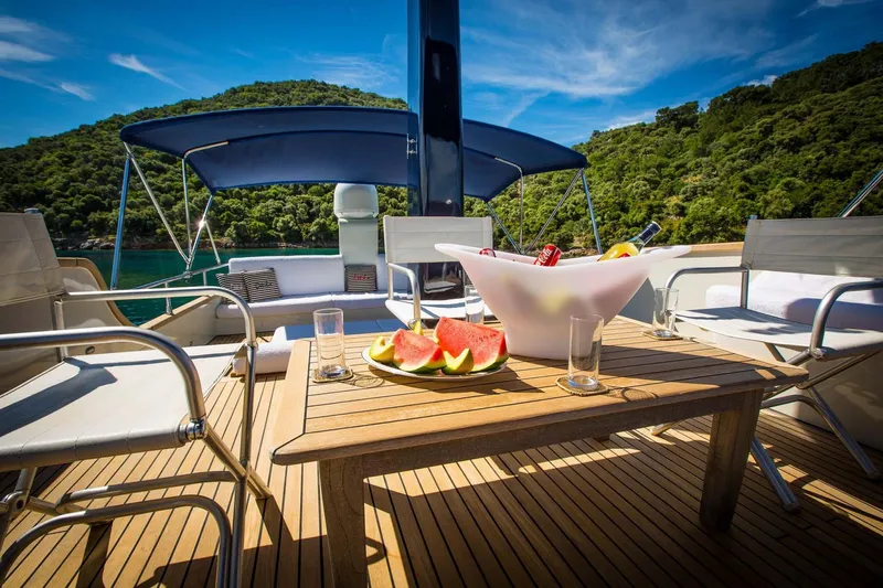 Dali Yacht Photos Pics Luxury yacht deck with fruit platter, Custom 28M, 2006, scenic ocean view.