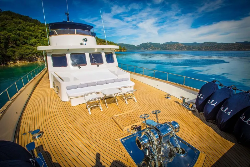 Dali Yacht Photos Pics Luxurious 2006 Custom 28M yacht on serene waters with scenic mountain backdrop.