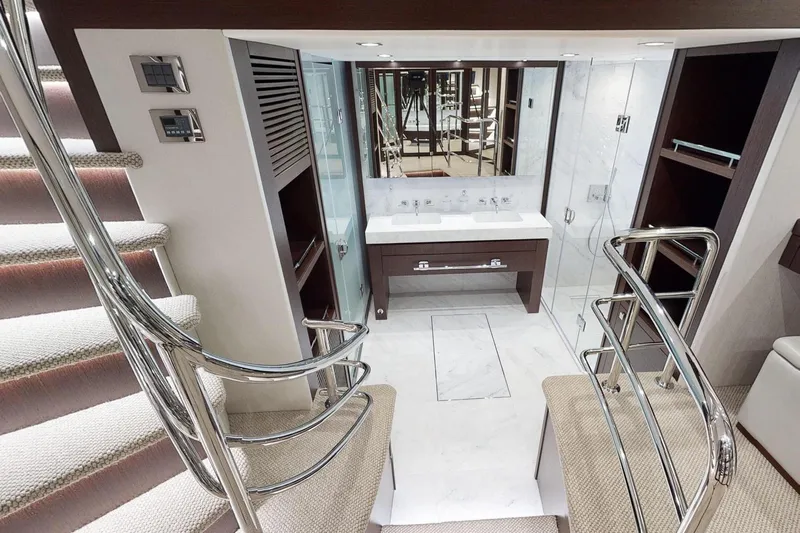  Yacht Photos Pics Luxurious interior of 2018 Sunseeker 95 Yacht featuring elegant staircase and modern bathroom.