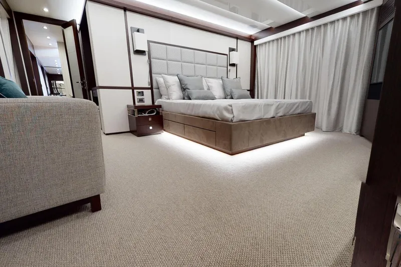  Yacht Photos Pics Luxurious bedroom interior on 2018 Sunseeker 95 Yacht, featuring elegant design and ambient lighting.