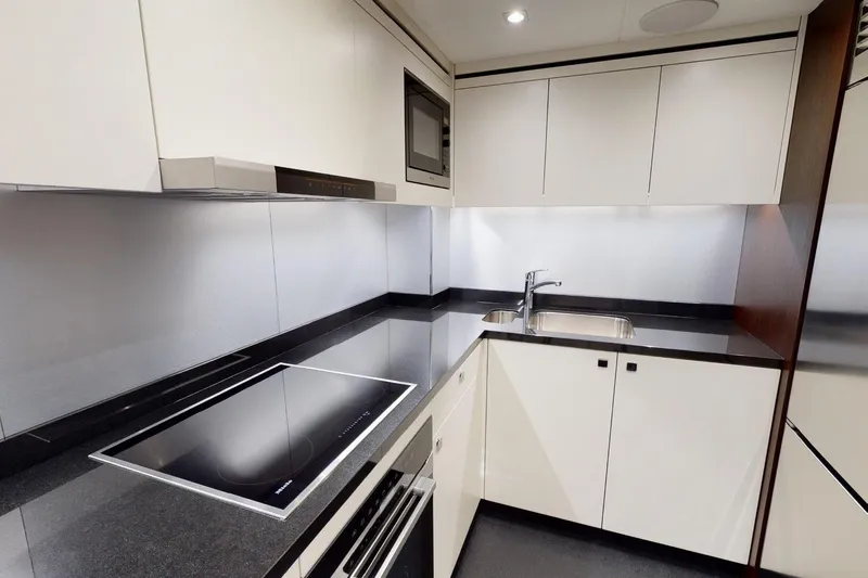  Yacht Photos Pics Modern kitchen interior on 2018 Sunseeker 95 Yacht, featuring sleek countertops and built-in appliances.