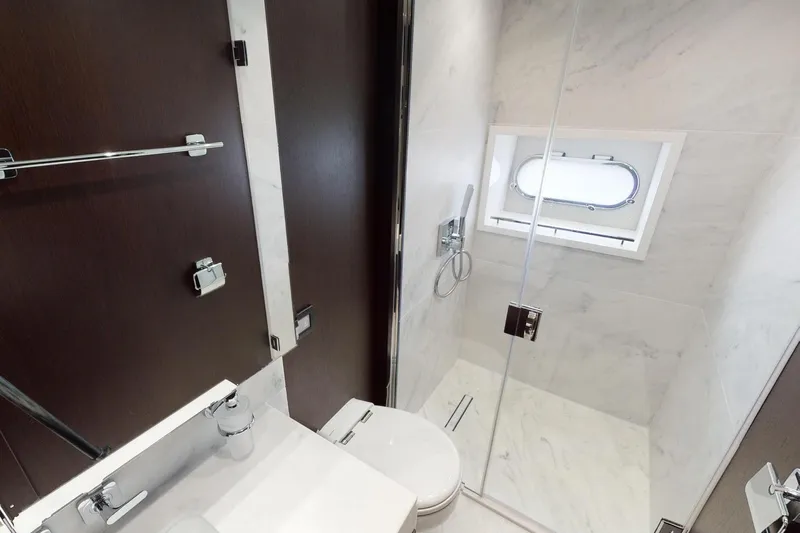  Yacht Photos Pics Luxurious bathroom in 2018 Sunseeker 95 Yacht with modern fixtures and elegant design.