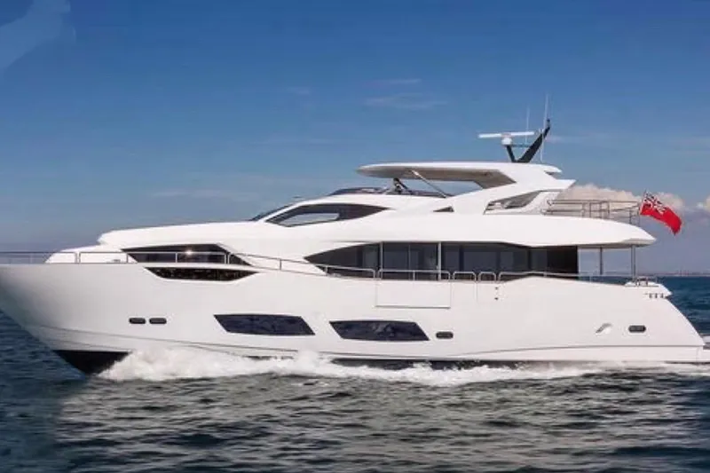  Yacht Photos Pics 2018 Sunseeker 95 Yacht cruising on open water under clear blue sky.