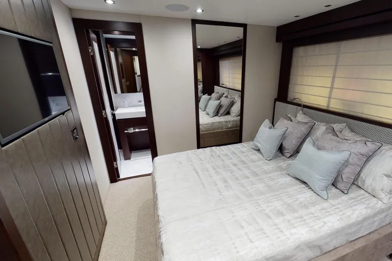  Yacht Photos Pics Luxurious bedroom interior of 2018 Sunseeker 95 Yacht with elegant decor and ensuite bathroom.