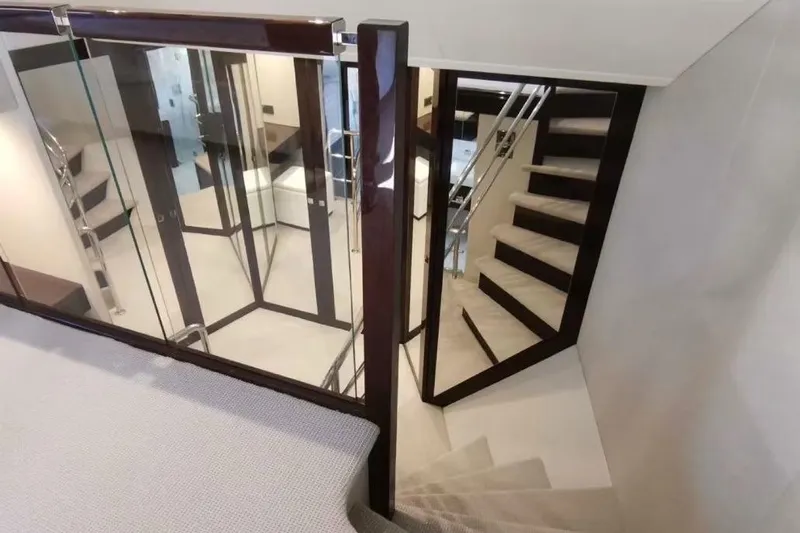  Yacht Photos Pics Luxurious interior staircase of 2018 Sunseeker 95 Yacht with modern design elements.
