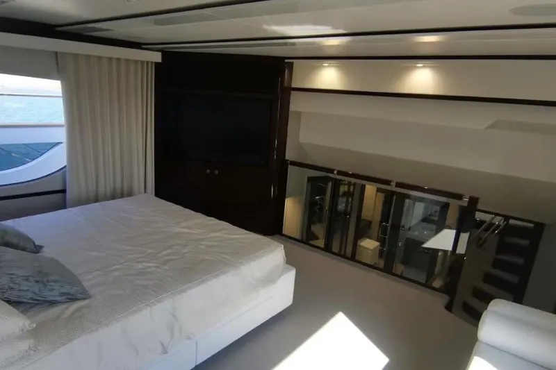 Yacht Photos Pics Luxurious bedroom interior of 2018 Sunseeker 95 Yacht with modern design and large windows.