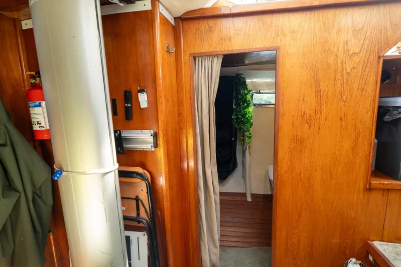 See The World Yacht Photos Pics Interior of a 1998 Custom model 49 boat with wood paneling and a cozy cabin.