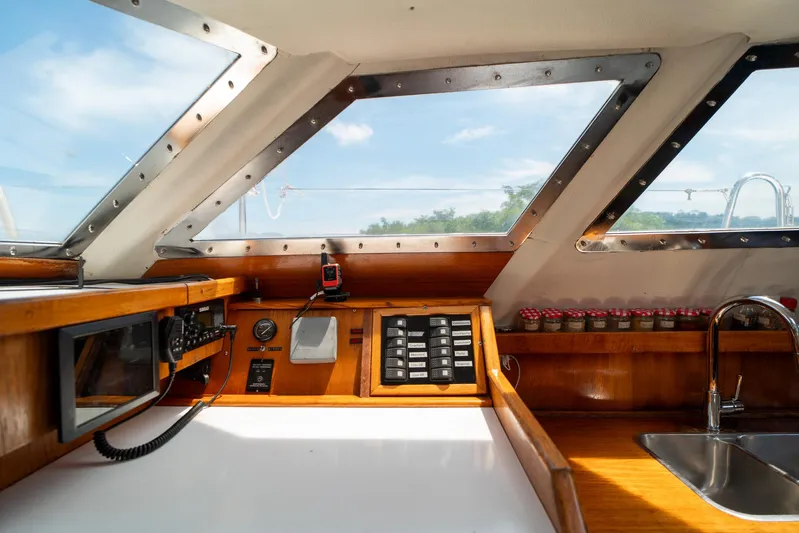 See The World Yacht Photos Pics Interior of a 1998 Custom 49 boat with navigation equipment and kitchen sink.