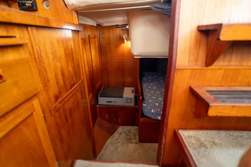 See The World Yacht Photos Pics Cozy wooden boat cabin interior with bed, Custom 49 model, 1998.