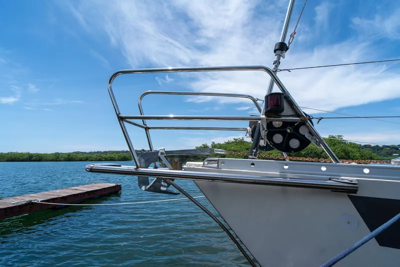 See The World Yacht Photos Pics Sailboat bow with stainless steel railings on a sunny day, Custom 49 model, 1998.