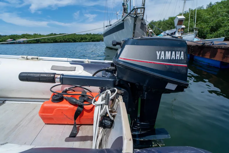 See The World Yacht Photos Pics Outboard motor on a boat docked by the water, featuring Yamaha branding.