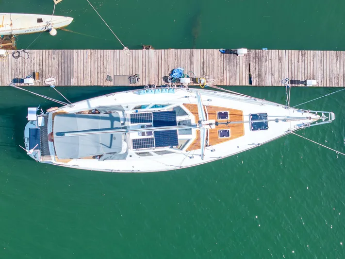 See The World Yacht Photos Pics Aerial view of a Custom 49 yacht docked, featuring solar panels, 1998 model.