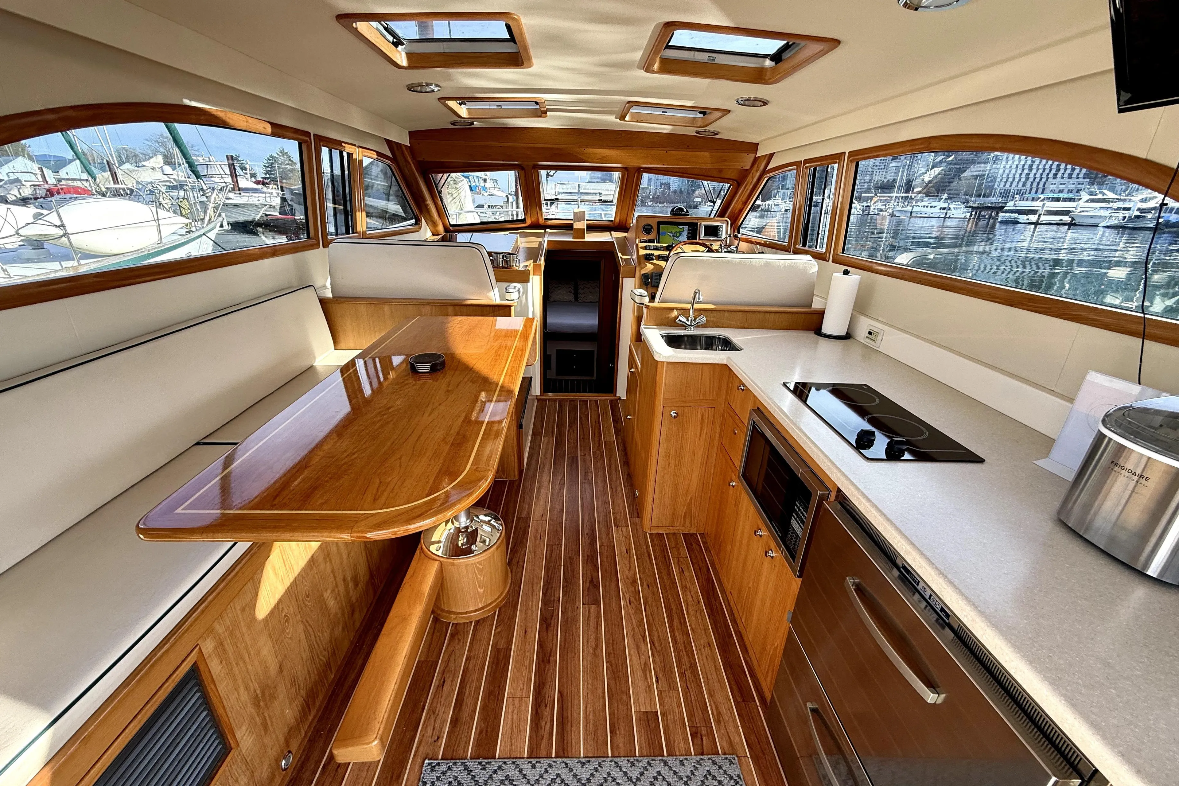 Luxurious interior of a 2012 Rivolta Coupe 4.5 yacht with wood finishes and modern amenities.