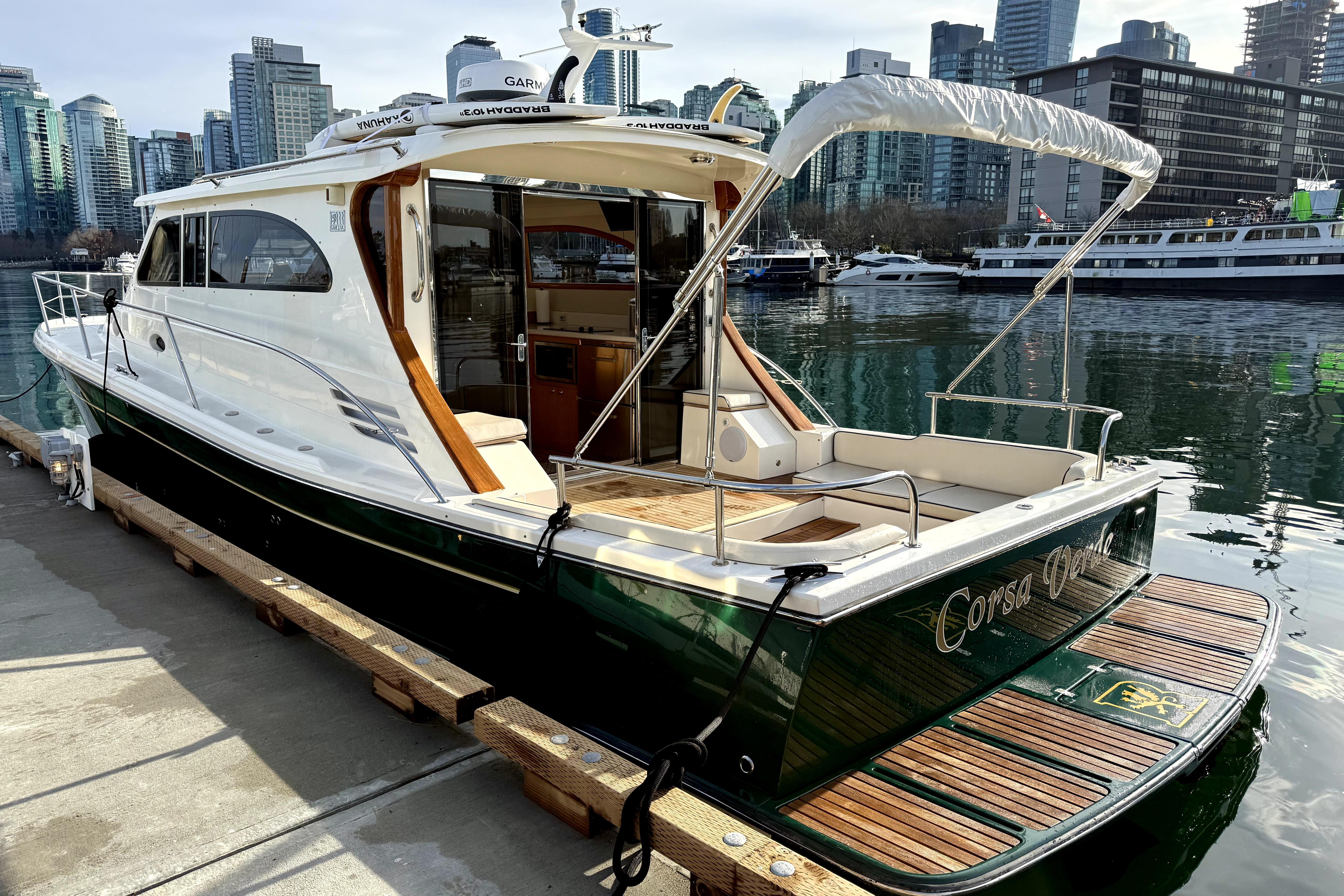 2012 Rivolta Coupe 4.5 yacht docked in urban marina with city skyline.