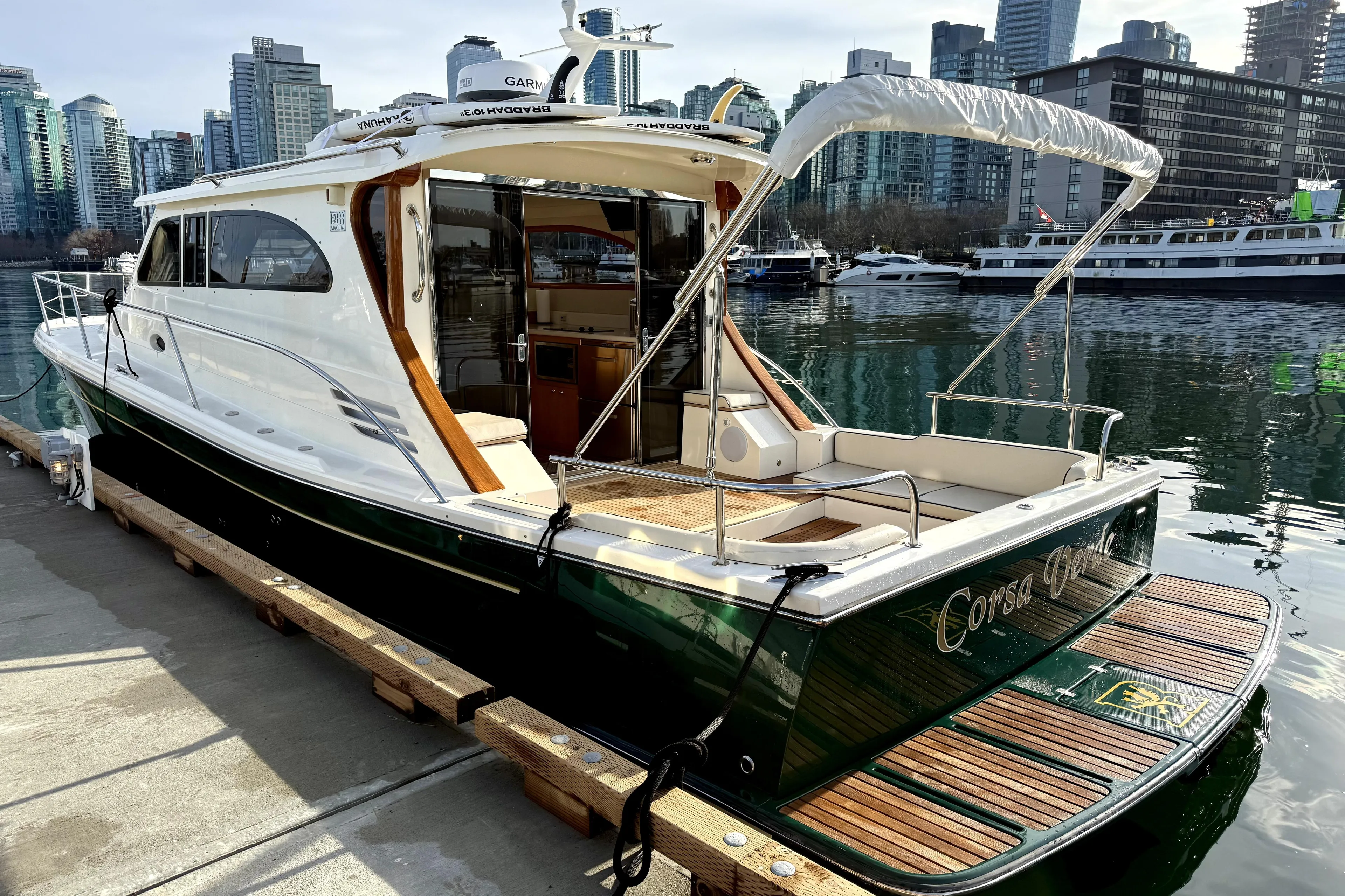 2012 Rivolta Coupe 4.5 yacht docked in urban marina with city skyline.