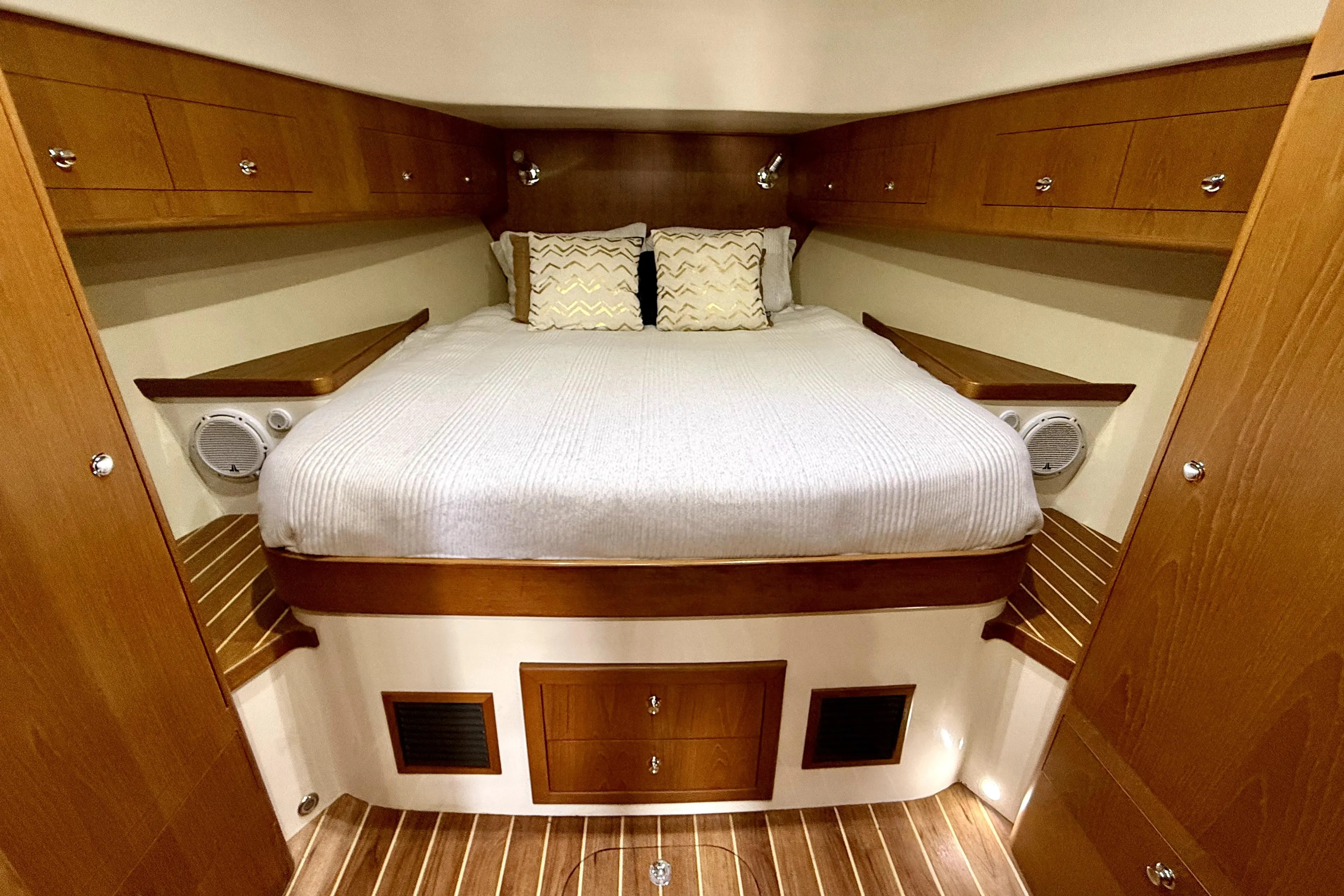 Luxurious 2012 Rivolta Coupe 4.5 cabin interior with cozy bed and wooden accents.