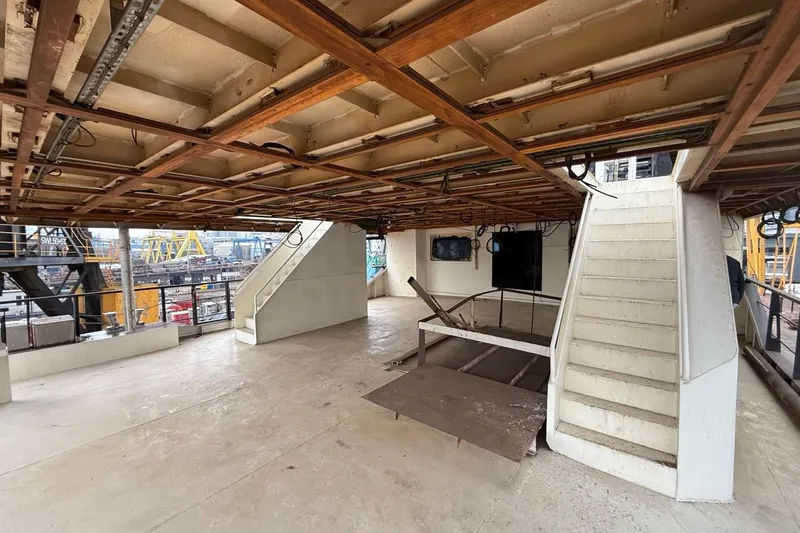 Soyaslan Custom Made Yacht Photos Pics Interior of a 2027 Soyaslan Custom ship under construction, featuring stairs and exposed ceiling.