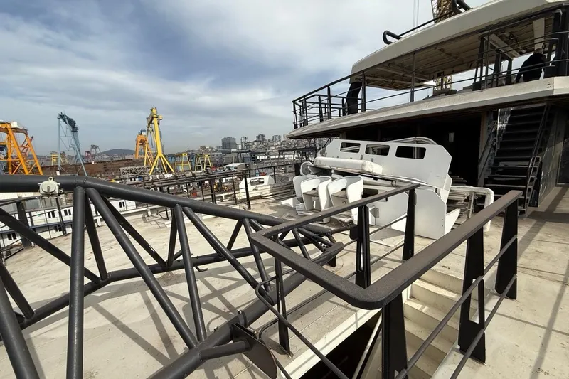 Soyaslan Custom Made Yacht Photos Pics Deck view of 2027 Soyaslan Custom yacht in a bustling shipyard.