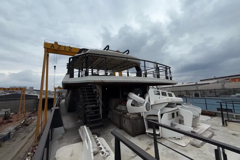 Soyaslan Custom Made Yacht Photos Pics A Soyaslan Custom 2027 yacht under construction at a shipyard with overcast skies.