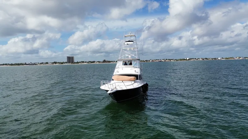Calypso Yacht Photos Pics 1996 Viking 47 Convertible yacht on open water under a partly cloudy sky.