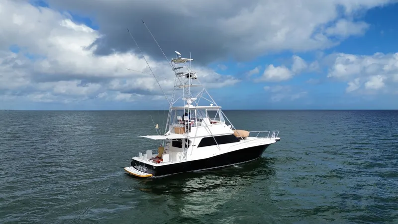 Calypso Yacht Photos Pics Viking 47 Convertible yacht from 1996 on open sea under cloudy sky.