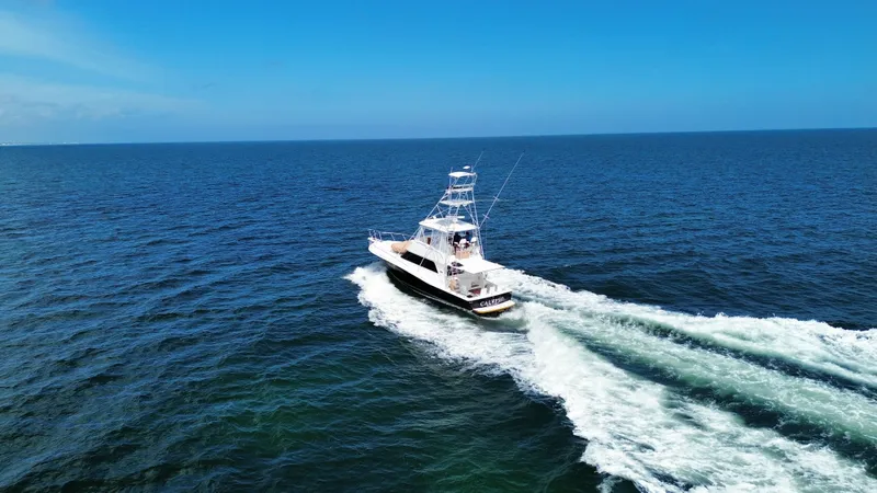 Calypso Yacht Photos Pics A 1996 Viking 47 Convertible yacht cruising on open blue ocean waters.