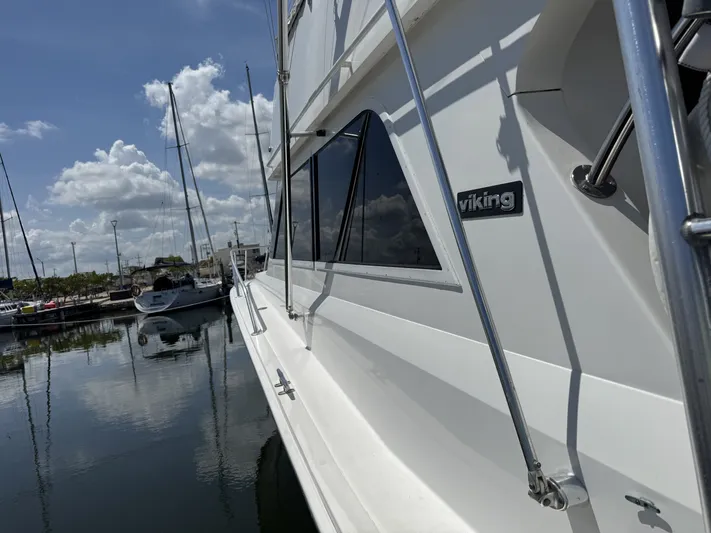Calypso Yacht Photos Pics 1996 Viking 47 Convertible yacht docked at marina under blue sky.