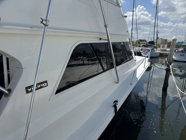 Calypso Yacht Photos Pics 1996 Viking 47 Convertible yacht docked at marina under blue sky.