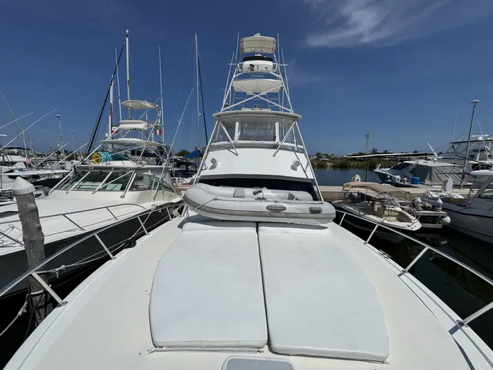 Calypso Yacht Photos Pics 1996 Viking 47 Convertible yacht docked at marina under clear blue sky.