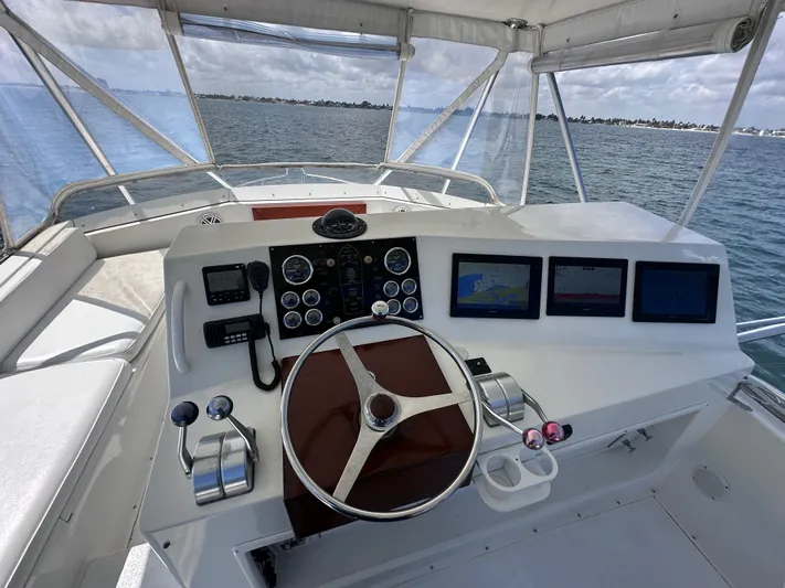Calypso Yacht Photos Pics Helm of 1996 Viking 47 Convertible yacht with navigation screens and controls.
