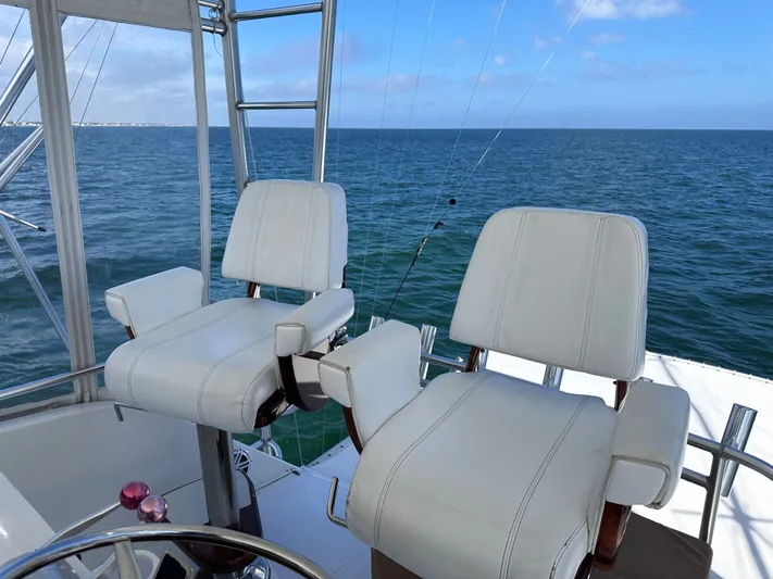 Calypso Yacht Photos Pics Captain's chairs on a 1996 Viking 47 Convertible yacht overlooking the ocean.