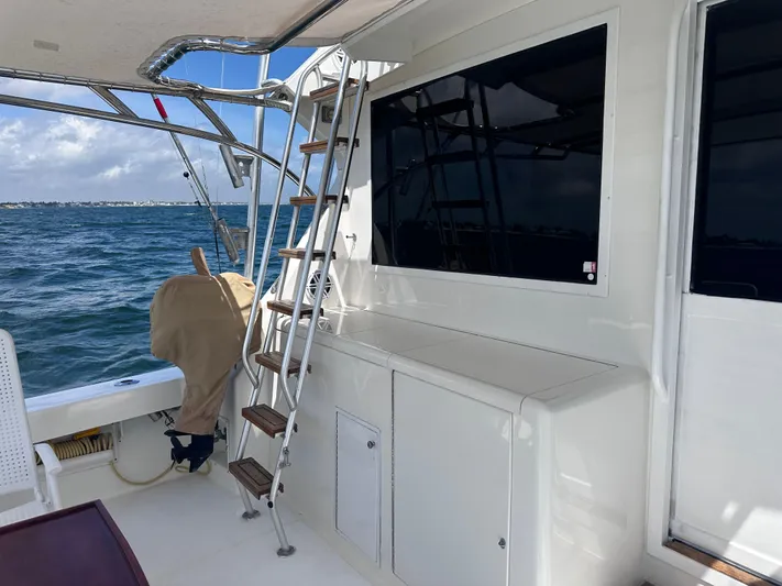 Calypso Yacht Photos Pics 1996 Viking 47 Convertible yacht deck with ladder and ocean view.