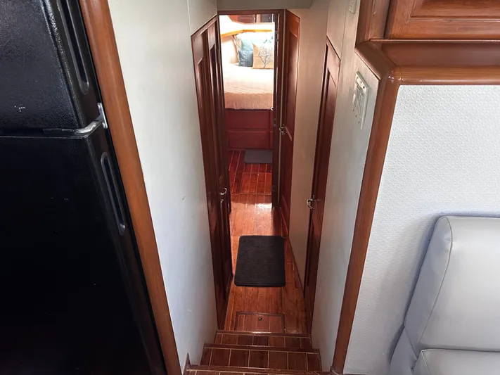 Calypso Yacht Photos Pics Interior hallway of 1996 Viking 47 Convertible yacht with wooden flooring.