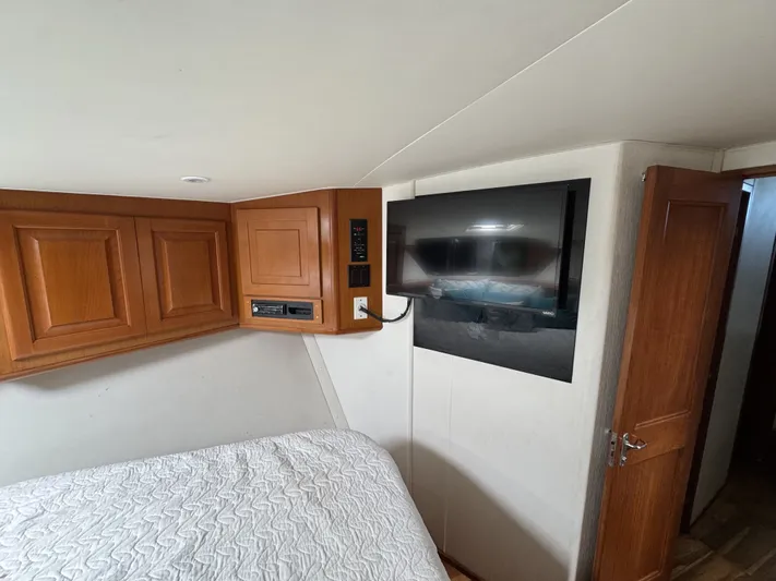 Calypso Yacht Photos Pics Interior of 1996 Viking 47 Convertible yacht with wood cabinets and mounted TV.
