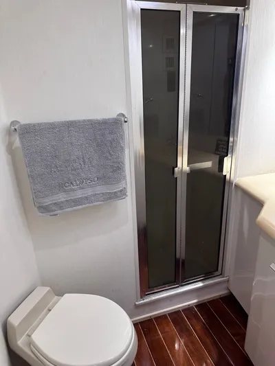 Calypso Yacht Photos Pics Bathroom interior of 1996 Viking 47 Convertible yacht with shower and towel.