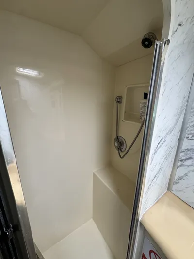 Calypso Yacht Photos Pics Shower area inside a 1996 Viking 47 Convertible yacht, featuring a handheld showerhead.