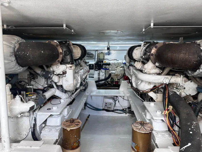 Calypso Yacht Photos Pics Engine room of a 1996 Viking 47 Convertible yacht, showcasing dual engines and mechanical components.