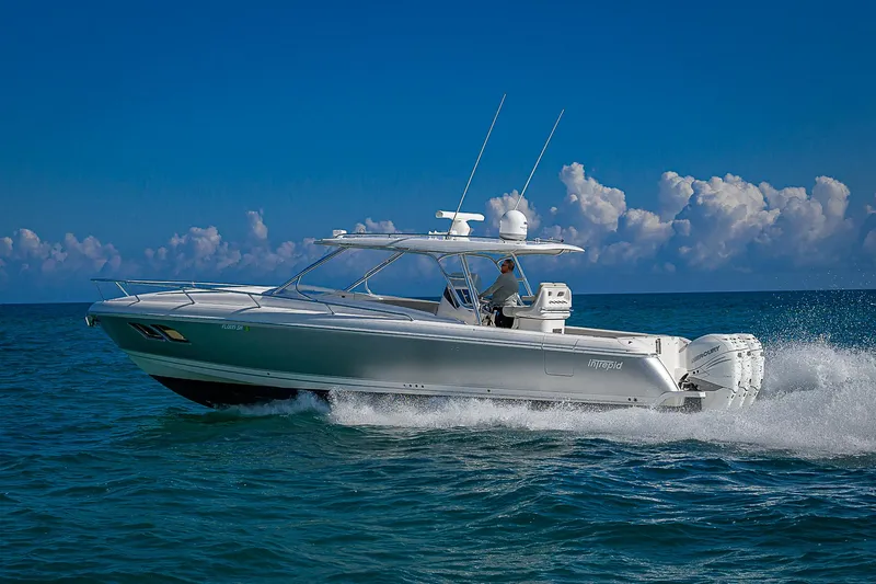  Yacht Photos Pics 2020 Intrepid 407 Cuddy cruising on open ocean under clear blue sky.