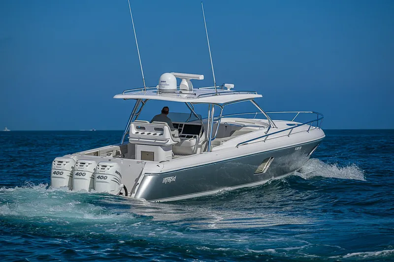  Yacht Photos Pics 2020 Intrepid 407 Cuddy cruising on open water, featuring triple outboard engines.