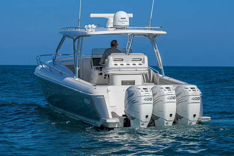  Yacht Photos Pics 2020 Intrepid 407 Cuddy boat with triple engines cruising on open water.