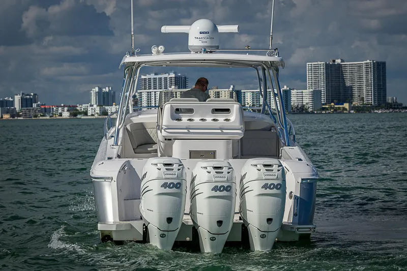  Yacht Photos Pics 2020 Intrepid 407 Cuddy boat with triple 400 engines on water, city skyline in background.