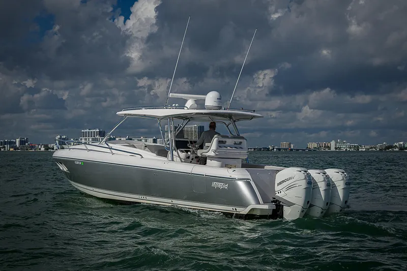  Yacht Photos Pics 2020 Intrepid 407 Cuddy boat cruising on open water under cloudy skies.