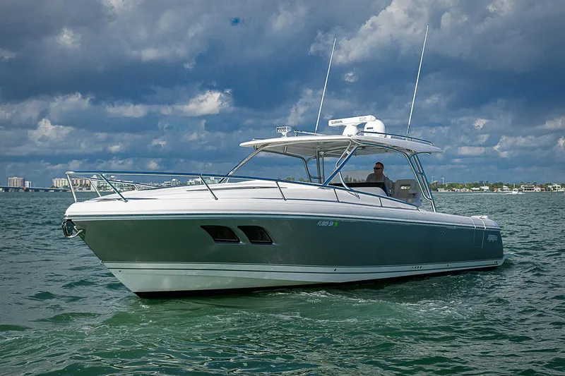  Yacht Photos Pics 2020 Intrepid 407 Cuddy boat cruising on open water under cloudy skies.
