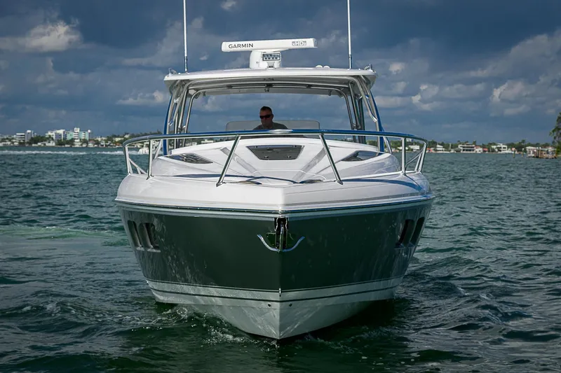  Yacht Photos Pics 2020 Intrepid 407 Cuddy boat cruising on open water under cloudy skies.
