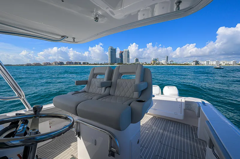  Yacht Photos Pics Intrepid 407 Cuddy 2020 boat interior with ocean view and city skyline.