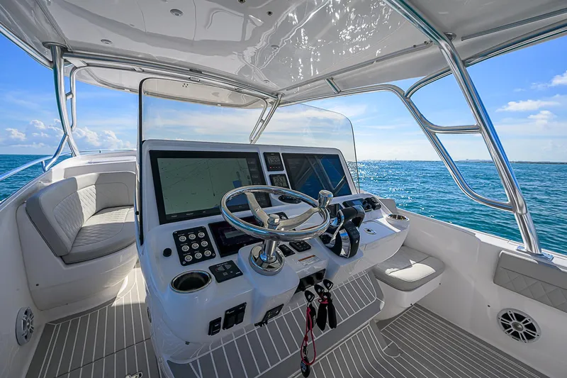  Yacht Photos Pics 2020 Intrepid 407 Cuddy boat helm with ocean view, featuring modern controls and seating.