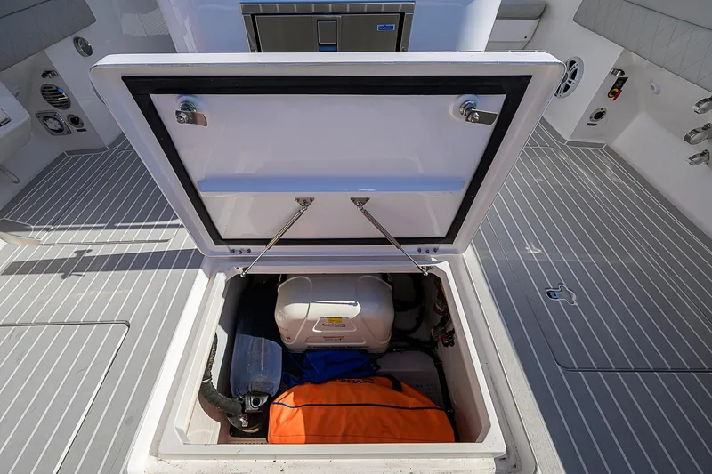  Yacht Photos Pics Storage compartment on 2020 Intrepid 407 Cuddy boat, open with gear inside.