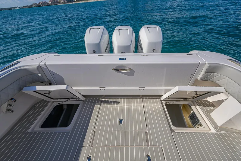  Yacht Photos Pics Intrepid 407 Cuddy 2020 boat deck with open storage compartments and triple engines.
